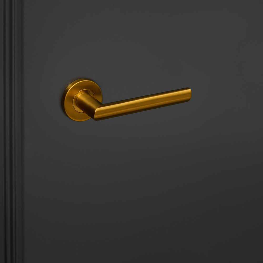 Ragusa_goud_rond_rozet_zwarte_deur